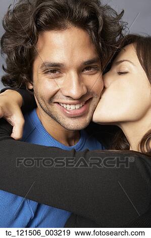 Hispanic woman hugging and kissing boyfriend View Large Photo Image Stock Photo - Hispanic woman hugging and kissing boyfriend. Fotosearch