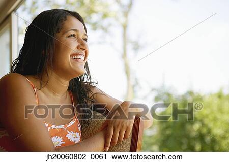 Hispanic woman laughing in chair View Large Photo Image Stock Image - Hispanic woman laughing in chair. Fotosearch