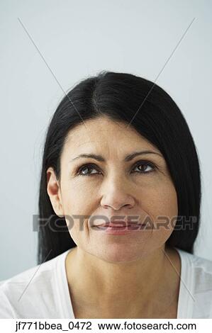 Stock Image - Hispanic woman looking up. Fotosearch