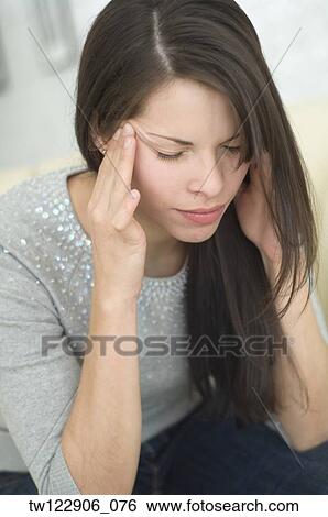 Hispanic woman rubbing head View Large Photo Image Stock Photograph - Hispanic woman rubbing head. Fotosearch