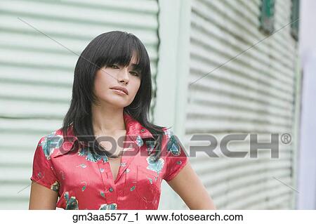 Hispanic woman standing in front of aluminum siding View Large Photo Image Stock Image - Hispanic woman standing in front of aluminum siding. Fotosearch