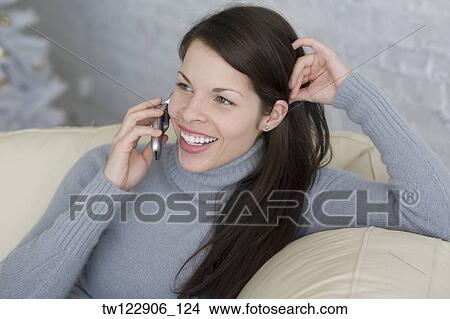 Hispanic woman talking on cell phone View Large Photo Image Picture - Hispanic woman talking on cell phone. Fotosearch