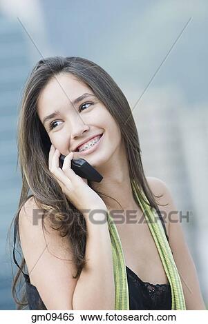 Hispanic woman talking on cell phone View Large Photo Image Stock Photography - Hispanic woman talking on cell phone. Fotosearch