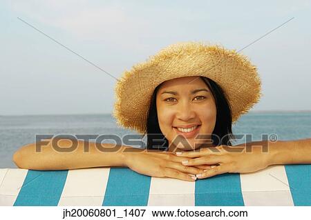 Hispanic woman wearing straw hat View Large Photo Image Stock Photo - Hispanic woman wearing straw hat. Fotosearch