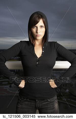 Stock Photography - Hispanic woman with hands on hips. Fotosearch