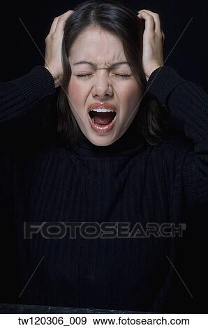 Hispanic woman yelling and holding head View Large Photo Image Stock Photo - Hispanic woman yelling and holding head. Fotosearch