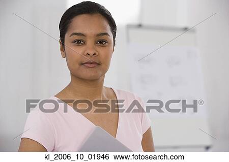 Indian businesswoman holding notebook View Large Photo Image Stock Photograph - Indian businesswoman holding notebook. Fotosearch