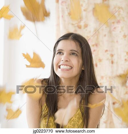Leaves raining down on Hispanic woman View Large Photo Image Stock Image - Leaves raining down on Hispanic woman. Fotosearch