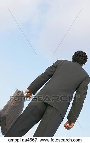 Low angle view of African businessman View Large Photo Image Stock Photo - Low angle view of African businessman. Fotosearch