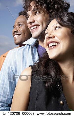 Low angle view of three young friends View Large Photo Image Stock Image - Low angle view of three young friends. Fotosearch