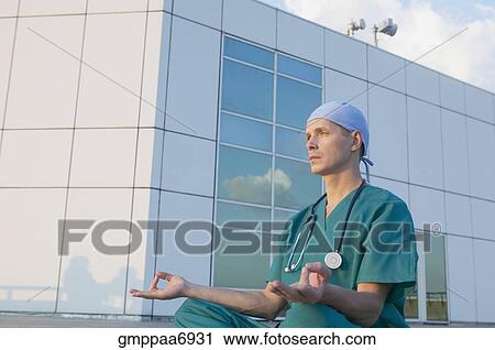 Stock Image - Male doctor meditating. Fotosearch