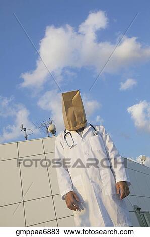 Stock Image - Male doctor wearing bag over head. Fotosearch