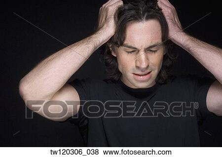 Man rubbing temples with eyes closed View Large Photo Image Stock Photo - Man rubbing temples with eyes closed. Fotosearch