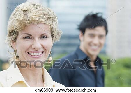Stock Photo - Mid Adult woman smiling outdoors. Fotosearch