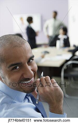 Middle Eastern businessman in conference room View Large Photo Image Stock Image - Middle Eastern businessman in conference room. Fotosearch