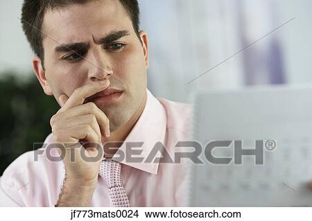 Middle Eastern businessman looking at paperwork View Large Photo Image Picture - Middle Eastern businessman looking at paperwork. Fotosearch