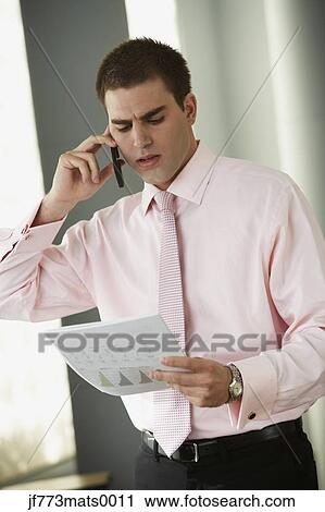Stock Image - Middle Eastern businessman looking at paperwork. Fotosearch