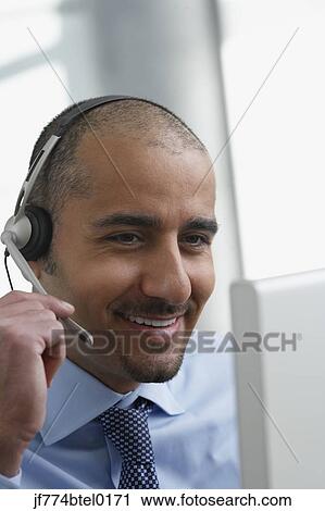 Middle Eastern businessman wearing headset View Large Photo Image Stock Image - Middle Eastern businessman wearing headset. Fotosearch