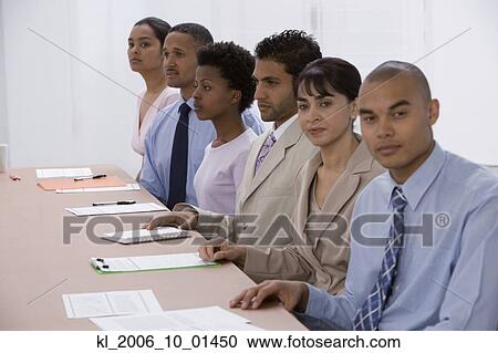 Stock Image - Multi-ethnic businesspeople at meeting. Fotosearch