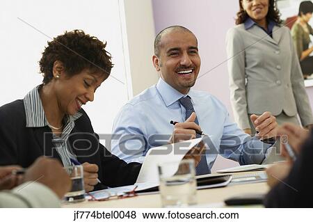 Multi-ethnic businesspeople at meeting View Large Photo Image Stock Photo - Multi-ethnic businesspeople at meeting. Fotosearch