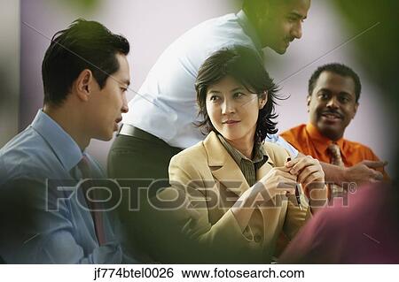 Multi-ethnic businesspeople at meeting View Large Photo Image Stock Photograph - Multi-ethnic businesspeople at meeting. Fotosearch