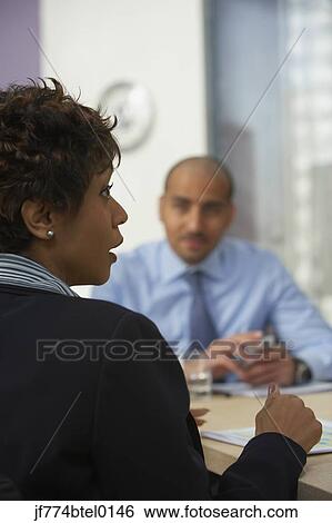 Multi-ethnic businesspeople at meeting View Large Photo Image Stock Photograph - Multi-ethnic businesspeople at meeting. Fotosearch