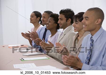 Stock Image - Multi-ethnic businesspeople clapping. Fotosearch