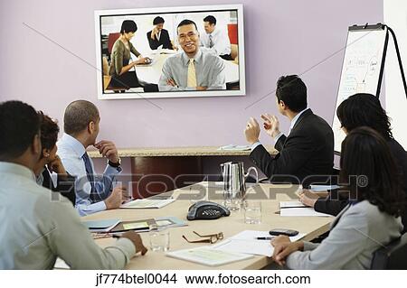 Multi-ethnic businesspeople having video conference View Large Photo Image Picture - Multi-ethnic businesspeople having video conference. Fotosearch