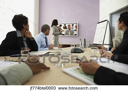 Multi-ethnic businesspeople having video conference View Large Photo Image Stock Image - Multi-ethnic businesspeople having video conference. Fotosearch