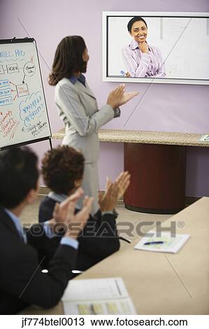 Multi-ethnic businesspeople having video conference View Large Photo Image Stock Image - Multi-ethnic businesspeople having video conference. Fotosearch