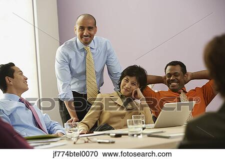 Multi-ethnic businesspeople having meeting View Large Photo Image Stock Image - Multi-ethnic businesspeople having meeting. Fotosearch