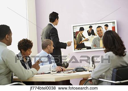 Multi-ethnic businesspeople having video conference View Large Photo Image Stock Photo - Multi-ethnic businesspeople having video conference. Fotosearch