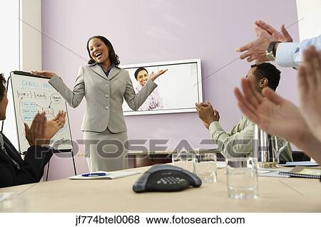 Stock Photo - Multi-ethnic businesspeople having video conference. Fotosearch