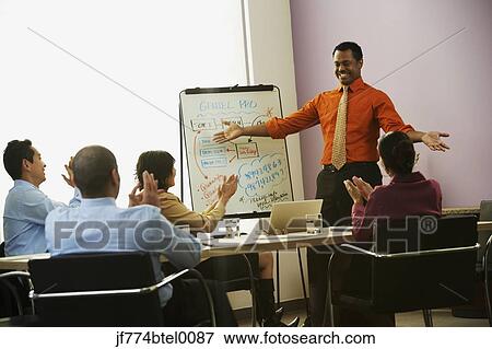 Multi-ethnic businesspeople having meeting View Large Photo Image Stock Photo - Multi-ethnic businesspeople having meeting. Fotosearch