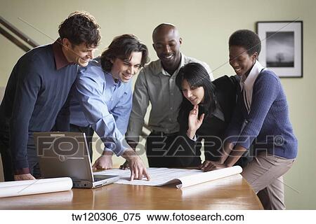 Multi-ethnic businesspeople looking at blueprints View Large Photo Image Stock Photography - Multi-ethnic businesspeople looking at blueprints. Fotosearch
