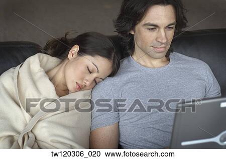 Multi-ethnic couple cuddling on sofa View Large Photo Image Stock Image - Multi-ethnic couple cuddling on sofa. Fotosearch