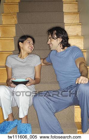 Multi-ethnic couple smiling at each other on stairs View Large Photo Image Stock Photography - Multi-ethnic couple smiling at each other on stairs. Fotosearch