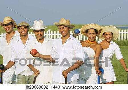 Multi-ethnic friends playing croquet View Large Photo Image Stock Image - Multi-ethnic friends playing croquet. Fotosearch