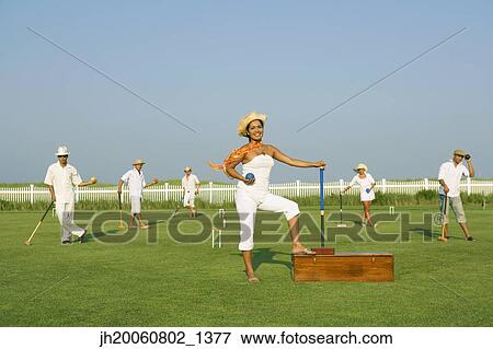 Multi-ethnic friends playing croquet View Large Photo Image Stock Photo - Multi-ethnic friends playing croquet. Fotosearch