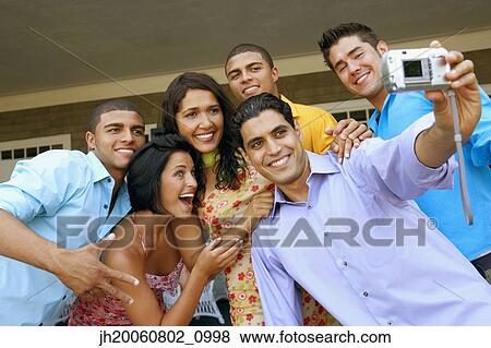 Multi-ethnic friends taking own photograph View Large Photo Image Stock Photo - Multi-ethnic friends taking own photograph. Fotosearch