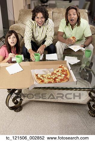 Multi-ethnic friends watching television and eating View Large Photo Image Stock Image - Multi-ethnic friends watching television and eating. Fotosearch