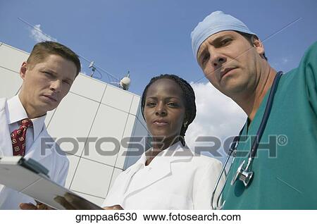 Stock Image - Multi-ethnic medical professionals outdoors. Fotosearch