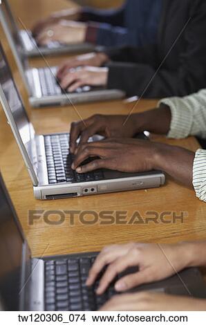 Multi-ethnic people typing on laptops View Large Photo Image Picture - Multi-ethnic people typing on laptops. Fotosearch