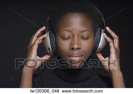 Portrait of African woman wearing headphones View Large Photo Image Stock Photo - Portrait of African woman wearing headphones. Fotosearch