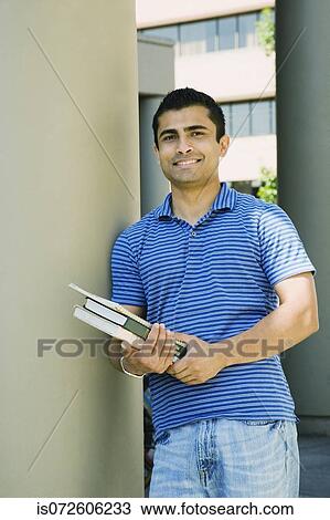 Portrait of Asian male college student holding books View Large Photo Image Stock Image - Portrait of Asian male college student holding books. Fotosearch