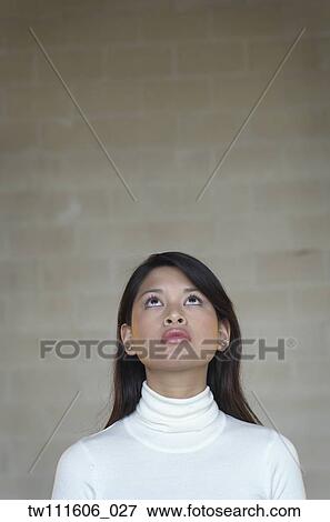 Stock Photo - Portrait of Asian woman looking up. Fotosearch