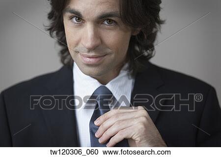 Portrait of businessman holding necktie View Large Photo Image Stock Image - Portrait of businessman holding necktie. Fotosearch