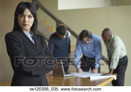 Portrait of businesswoman with coworkers in background View Large Photo Image Stock Photography - Portrait of businesswoman with coworkers in background. Fotosearch