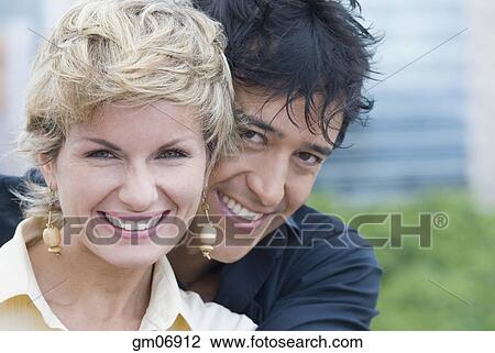 Stock Image - Portrait of couple hugging. Fotosearch