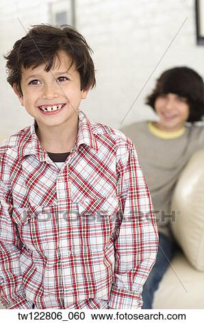 Portrait of Hispanic boy with brother in background View Large Photo Image Stock Image - Portrait of Hispanic boy with brother in background. Fotosearch